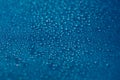 Drops blue texture. Wet water on glass background. Bubble pattern. Royalty Free Stock Photo