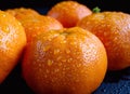 Drops of clean water on the peel of ripe tangerine