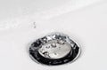 Drops of clean water on the sink drain valve. Royalty Free Stock Photo