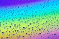 Drops on the glass against the background of the rainbow, textur Royalty Free Stock Photo