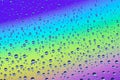 Drops on the glass against the background of the rainbow, texture and background Royalty Free Stock Photo