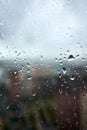 Drops on glass on rainy cloudy day evoke melancholy and sadness. View of city from the window. Selective focus Royalty Free Stock Photo