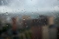 Drops on glass on rainy cloudy day evoke melancholy and sadness. View of city from the window. Selective focus Royalty Free Stock Photo