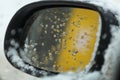 Drops of melting snow on the car mirror. Winter time. Snowfall. Shallow depth of field, macro. Royalty Free Stock Photo