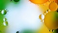 Drops of oil in water. Abstract rainbow background. Colored background of oil drops on the water surface. Copy space Royalty Free Stock Photo