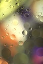 Drops of oil in water on a colored background. Abstract background with yellow and green circles of different sizes. Royalty Free Stock Photo