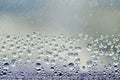 Drops Of Rain On Blue Glass Background. Street Bokeh Lights Out Of Focus. Abstract Backdrop Royalty Free Stock Photo