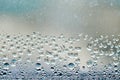 Drops Of Rain On Blue Glass Background. Street Bokeh Lights Out Of Focus. Abstract Backdrop Royalty Free Stock Photo