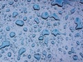 Drops of rain  on blue metal  surface Royalty Free Stock Photo