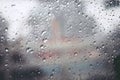 Drops Of Rain Drizzle on the glass windshield in the evening. street in the heavy rain. Royalty Free Stock Photo