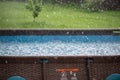 Drops of rain fall into the pool. Royalty Free Stock Photo