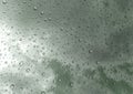 Drops of rain on glass , rain drops on clear window / rain drops with clouds / water drops on glass after rain background / water