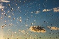 Drops of rain shining on a window glass blue sky in background Royalty Free Stock Photo