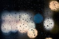 Drops of rain on window with abstract lights Royalty Free Stock Photo