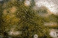 Drops of rain on the window glass on a blurred background. Royalty Free Stock Photo