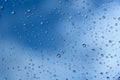 Drops of rain on a window pane. Shallow depth of field. Selective focus. Blue tone Royalty Free Stock Photo