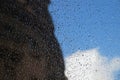 Drops of rain on the window, sky, cloud and silhouette of the building Royalty Free Stock Photo