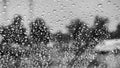 Drops of rain on the windshield; abstract landscape in the background; black and white Royalty Free Stock Photo