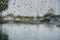 Drops of rain on the windshield; abstract landscape in the background Royalty Free Stock Photo