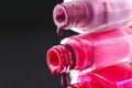 drops of red bearded pink nail polish flow from the bottle of the bottle on a black dark background with a copyspace Royalty Free Stock Photo