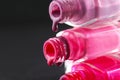 drops of red bearded pink nail polish flow from the bottle of the bottle on a black dark background with a copyspace Royalty Free Stock Photo