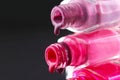 drops of red bearded pink nail polish flow from the bottle of the bottle on a black dark background with a copyspace Royalty Free Stock Photo