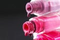 drops of red bearded pink nail polish flow from the bottle of the bottle on a black dark background with a copyspace Royalty Free Stock Photo