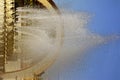 Drops and splashes from the water of a city fountain on a sunny day Royalty Free Stock Photo