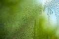 Drops of water for the background on window glass to abstract design and nature backdrop. Window after a summer rain Royalty Free Stock Photo