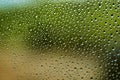 Drops of water for the background on window glass to abstract design and nature backdrop. Window after a summer rain Royalty Free Stock Photo