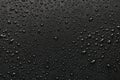 Drops of water on a black surface. Royalty Free Stock Photo