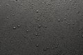 Drops of water on a black surface. Royalty Free Stock Photo