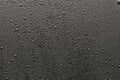 Drops of water on a black surface. Royalty Free Stock Photo
