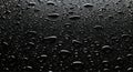 Drops of water on a black surface. The condensate. Top view. Free space Royalty Free Stock Photo