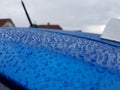 Drops of water on a blue car