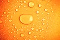 Drops of water on a color background. Toned orange