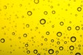 Drops of water on a color background. Yellow tone Royalty Free Stock Photo