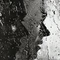 Drops of water on the glass. Black and white photo. Double faces behind.