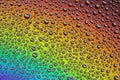 Drops of water on the glass, with the reflection of the rainbow Royalty Free Stock Photo