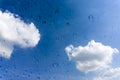 Drops of water on glass window over blue sky Royalty Free Stock Photo