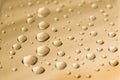 Drops of water on a golden metal surface. Abstract golden background made of water drops. Selective focus Royalty Free Stock Photo