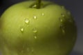 Drops of water on green apple close up Royalty Free Stock Photo