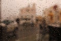 Drops of water from the rain flow down the glass. Raindrops on window. Sadness, longing, dullness, autumn depression, gloom. Royalty Free Stock Photo