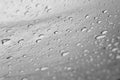 Drops of water after a rain flow down from a polyethylene film against a bokeh outdoors. homemade rain protection outside. Royalty Free Stock Photo
