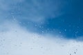 Drops of water from the rain on the glass. Window. Against the background of blue sky. Freshness of summer Royalty Free Stock Photo