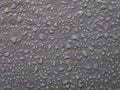 Drops of water after rain on a gray surface. Royalty Free Stock Photo