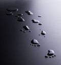 Drops of water splashed in the form of traces of human feet Royalty Free Stock Photo