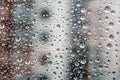 Drops of water on the window glass against a blurred background of a house on a rainy cloudy day Royalty Free Stock Photo