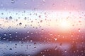 Drops of water on window glass after rain with dramatic blurred sunset on background. Idyllic tranquil nature wallpaper. Weather Royalty Free Stock Photo