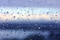 Drops of water on window glass after rain with dramatic blurred sunset on background. Idyllic tranquil nature wallpaper. Weather Royalty Free Stock Photo